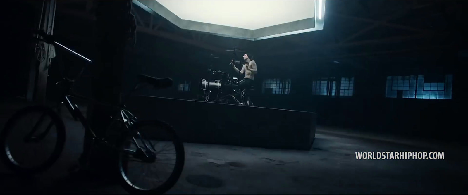 a man on a bike in a dark room