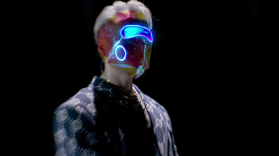 a man wearing a neon mask and a tie