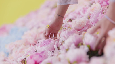 a close up of a person touching a bunch of flowers