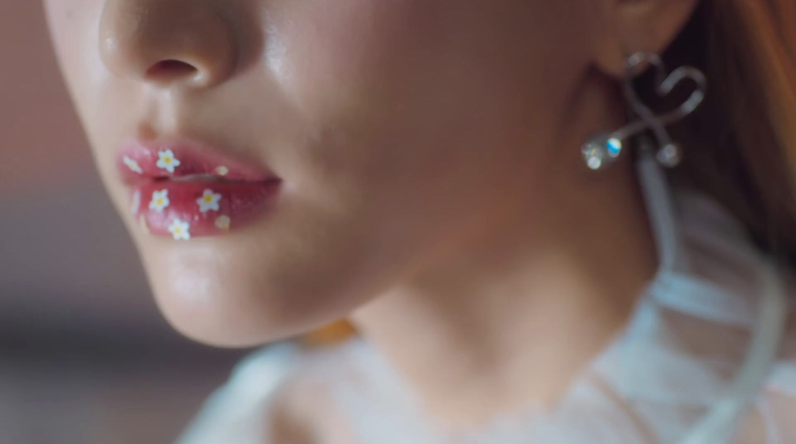 a close up of a woman wearing earrings