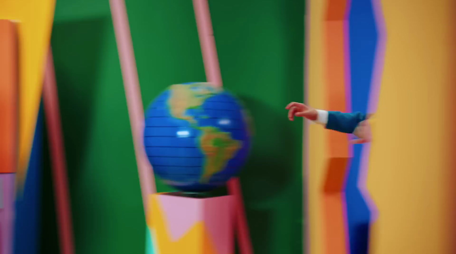 a small child standing in front of a colorful wall