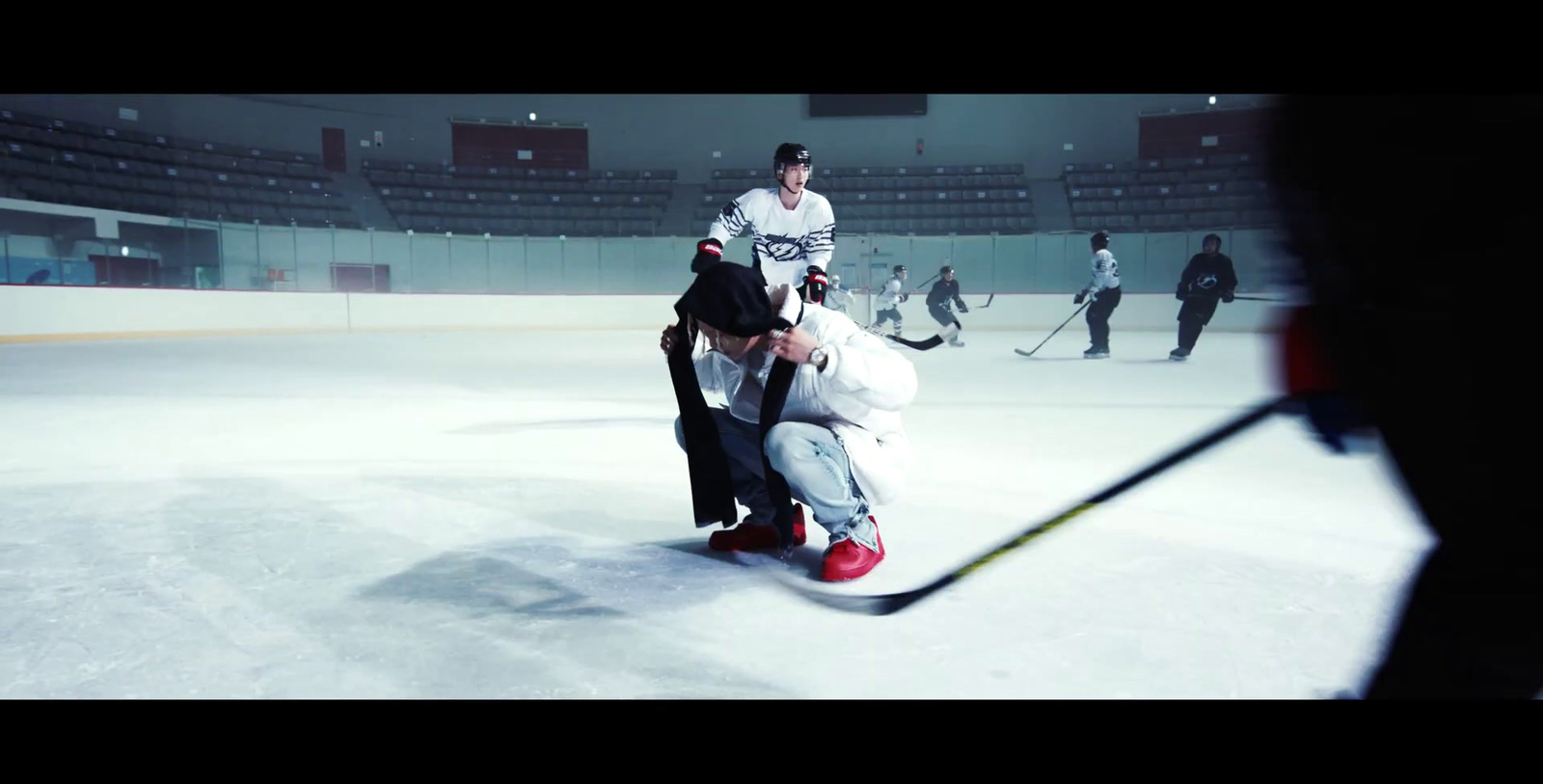 a group of people on a ice rink playing hockey