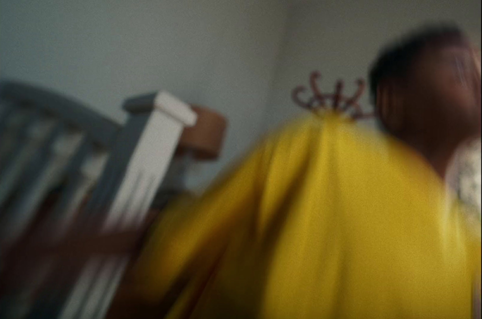 a blurry photo of a man in a yellow shirt