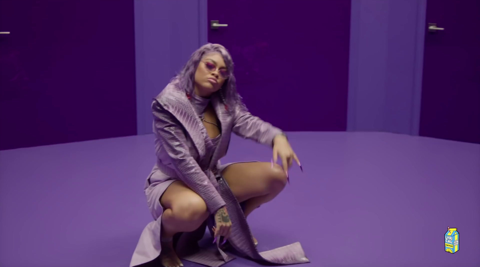 a woman sitting on the floor in a purple room