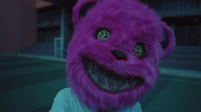 a person wearing a purple furry animal mask