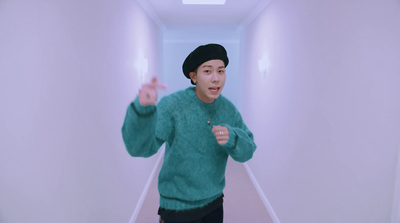 a man in a green sweater and a black hat