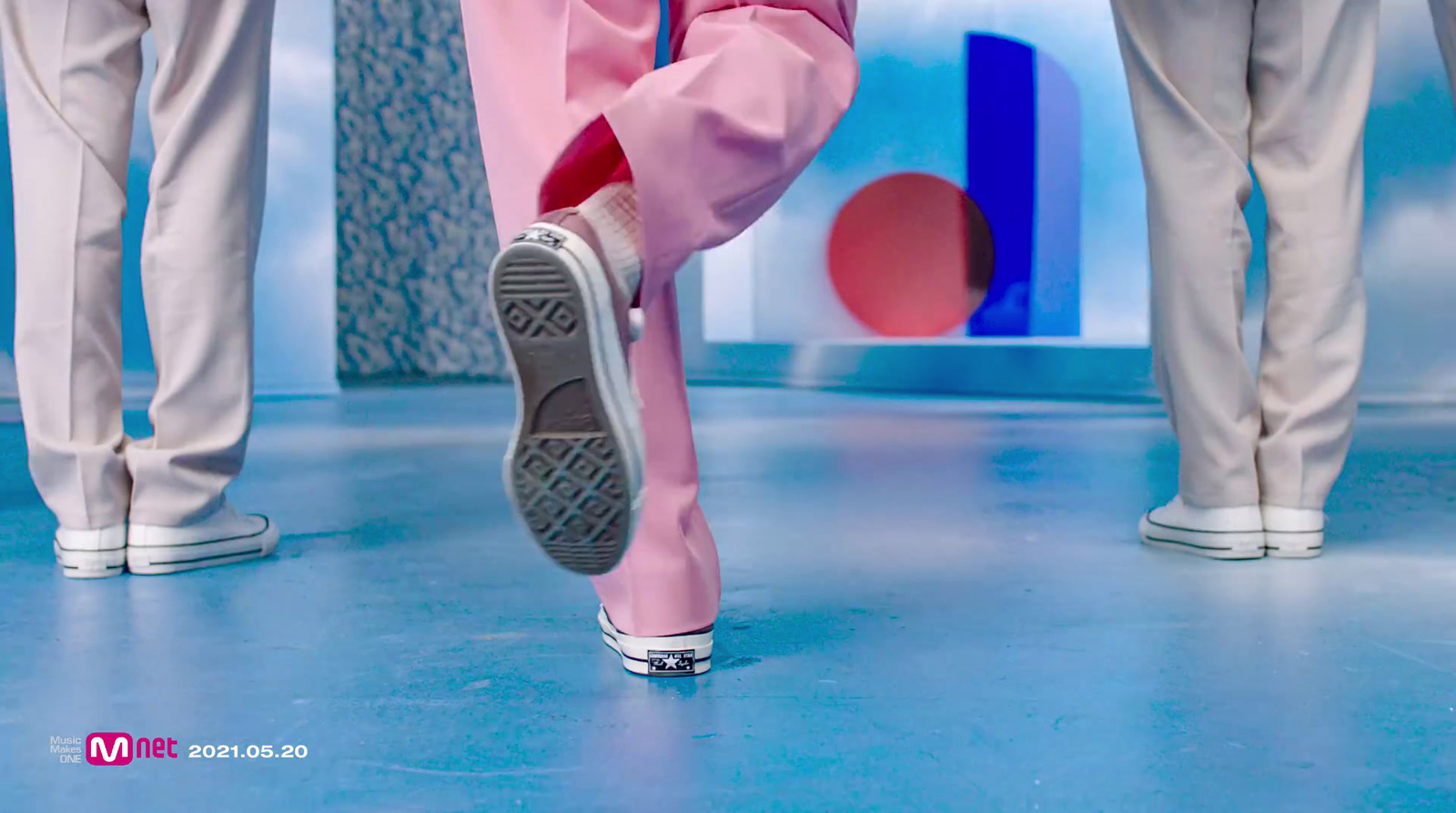 a close up of a person wearing pink pants and sneakers