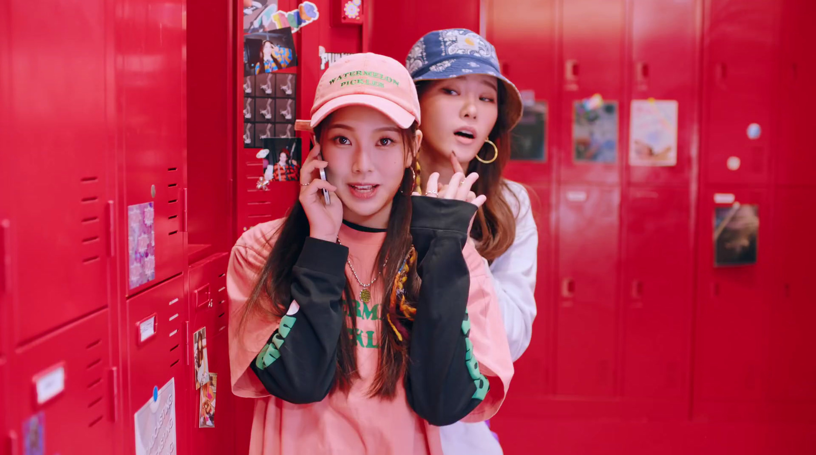 a couple of girls standing next to each other in a locker