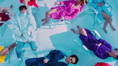 a group of people laying on top of a blue floor