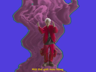 a man in a red suit standing in front of a purple background