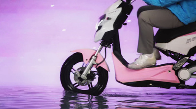 a person riding a pink scooter in the water