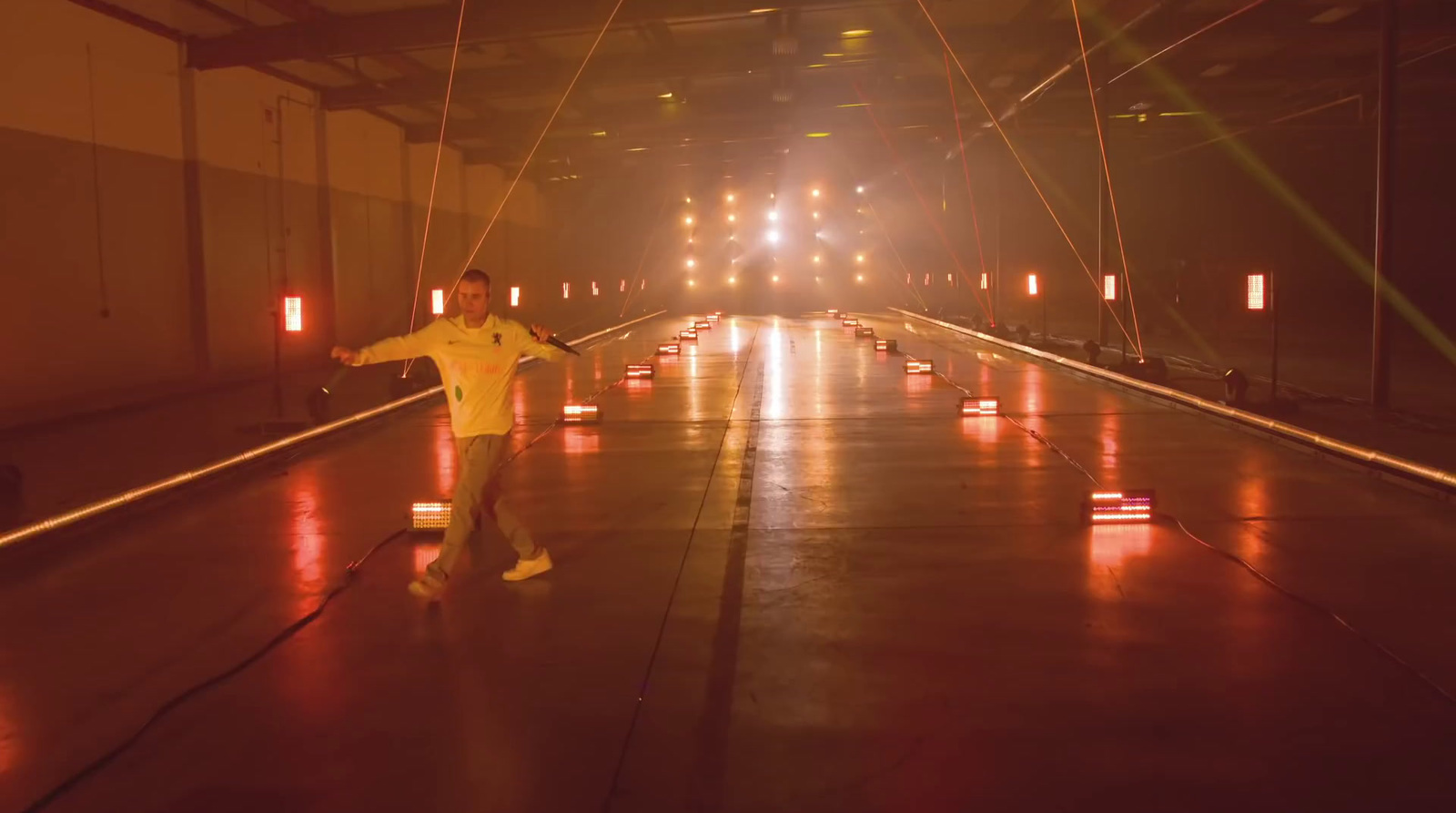 a man in a yellow suit standing in a tunnel