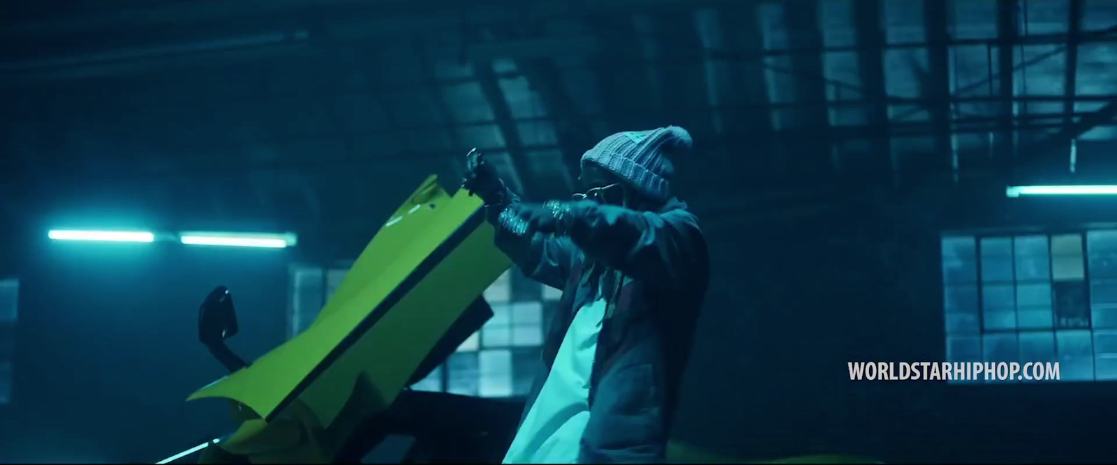 a man holding a snowboard in a warehouse