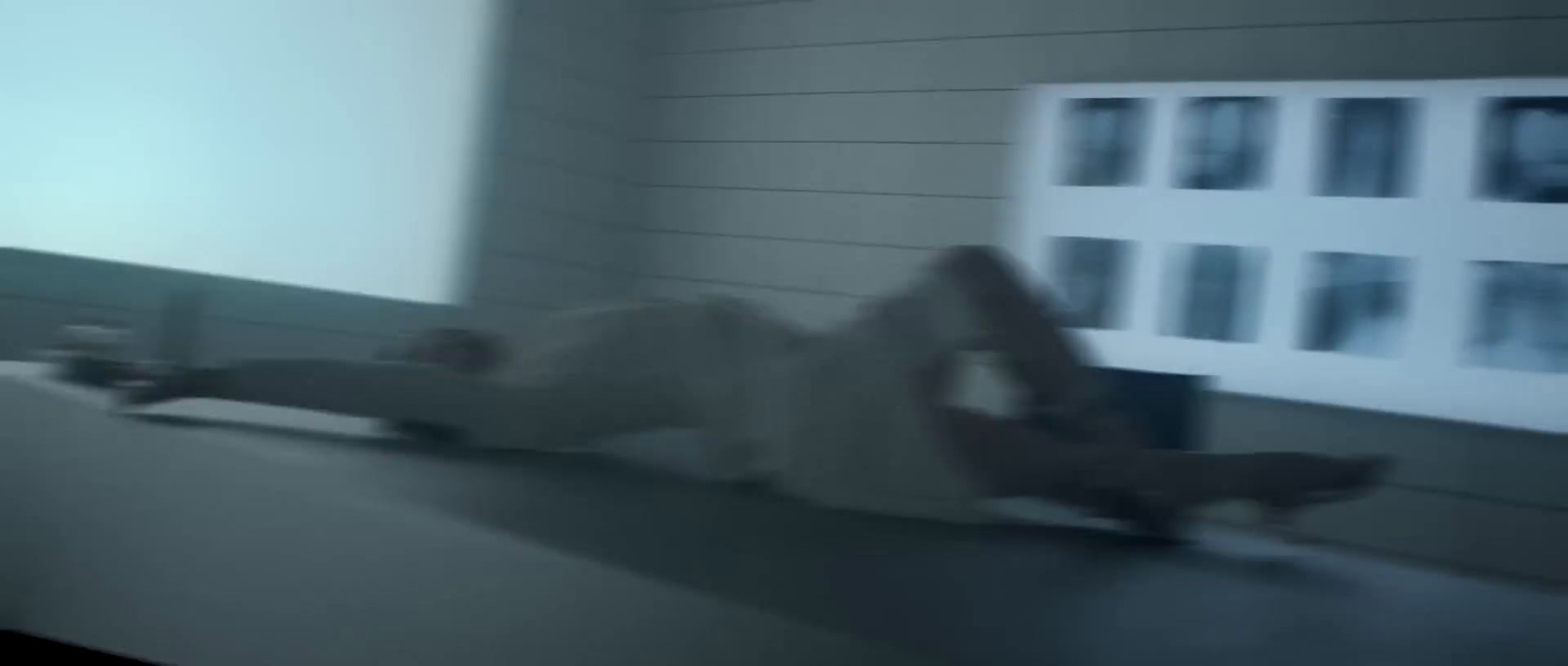 a blurry photo of a person laying on a ledge