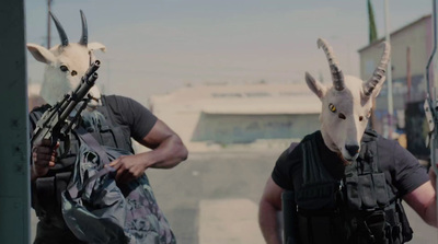 two men wearing goat heads with guns in their hands