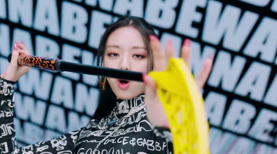 a woman holding a tennis racket in front of her face