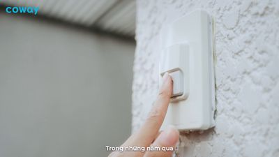 a person turning on a light switch on a wall