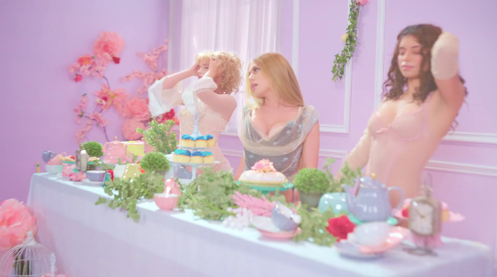 a group of women standing around a table