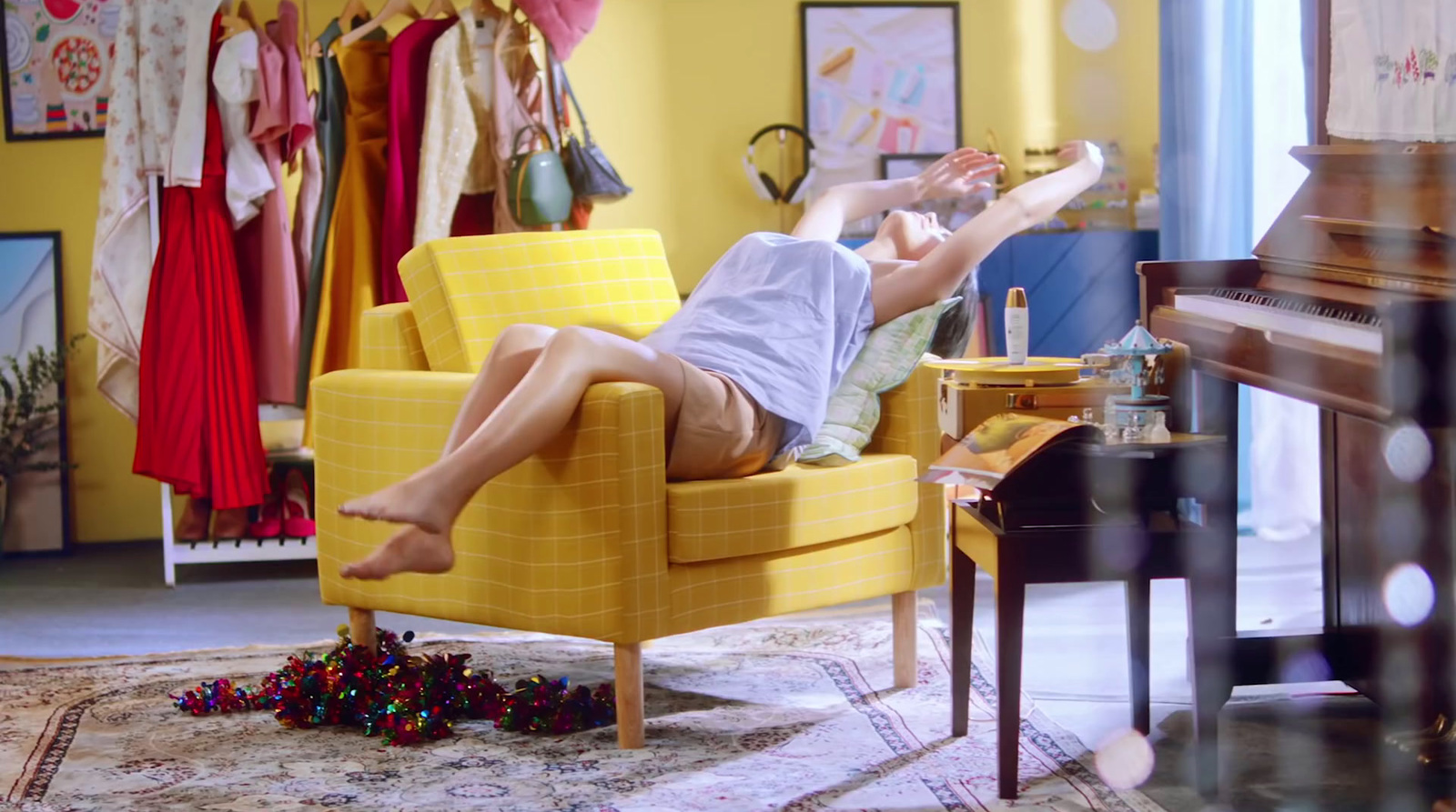 a woman laying on a yellow chair in a room