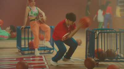 a group of young people playing a game of basketball