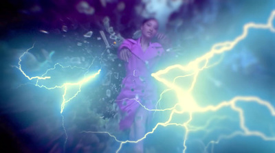 a woman standing in front of a lightning storm