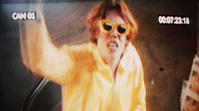 a man wearing sunglasses and a yellow shirt