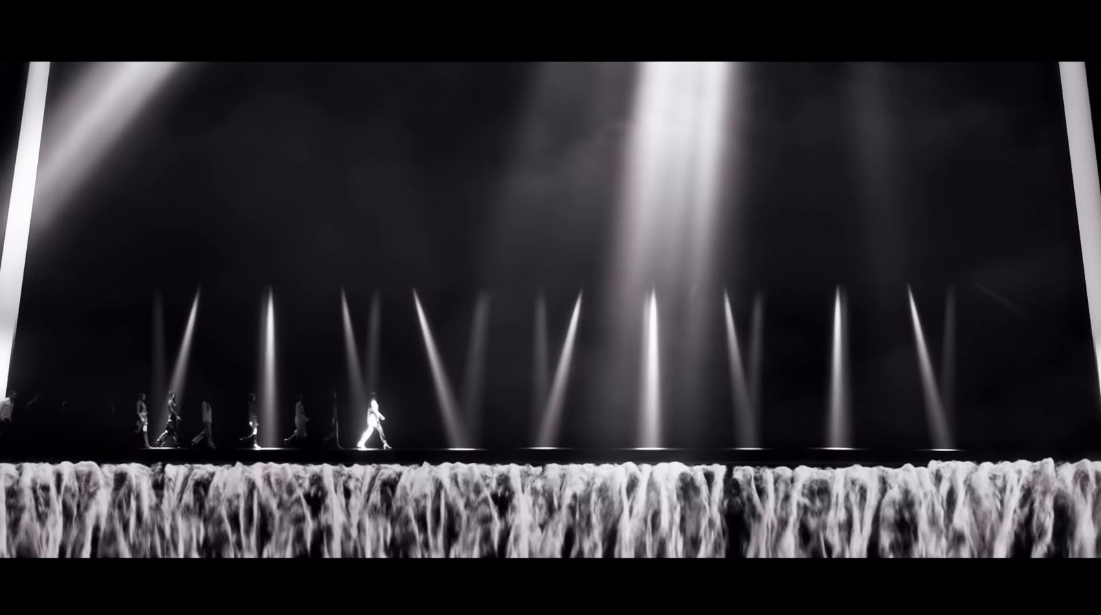 a black and white photo of a stage with lights