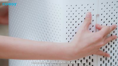 a person is pressing buttons on a wall