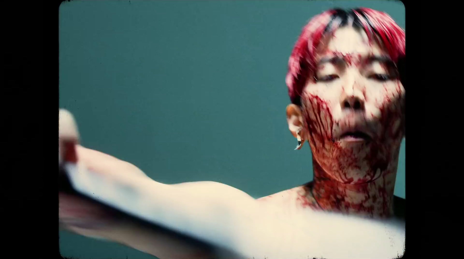 a woman with blood on her face and hands