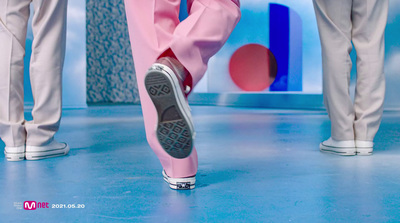 a pair of feet in pink pants and sneakers