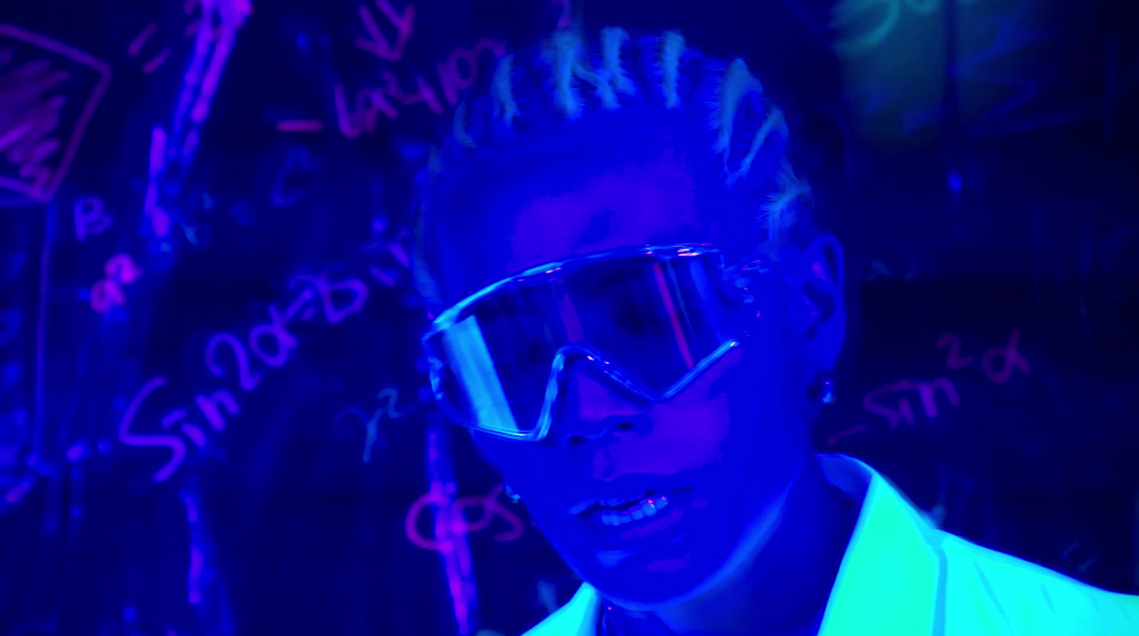 a man wearing sunglasses and a neon jacket