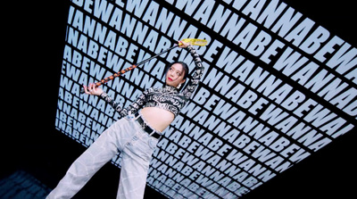 a woman holding a tennis racquet on top of a tennis court