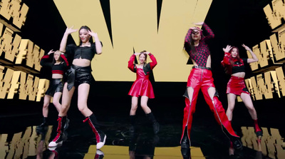 a group of women standing on top of a stage