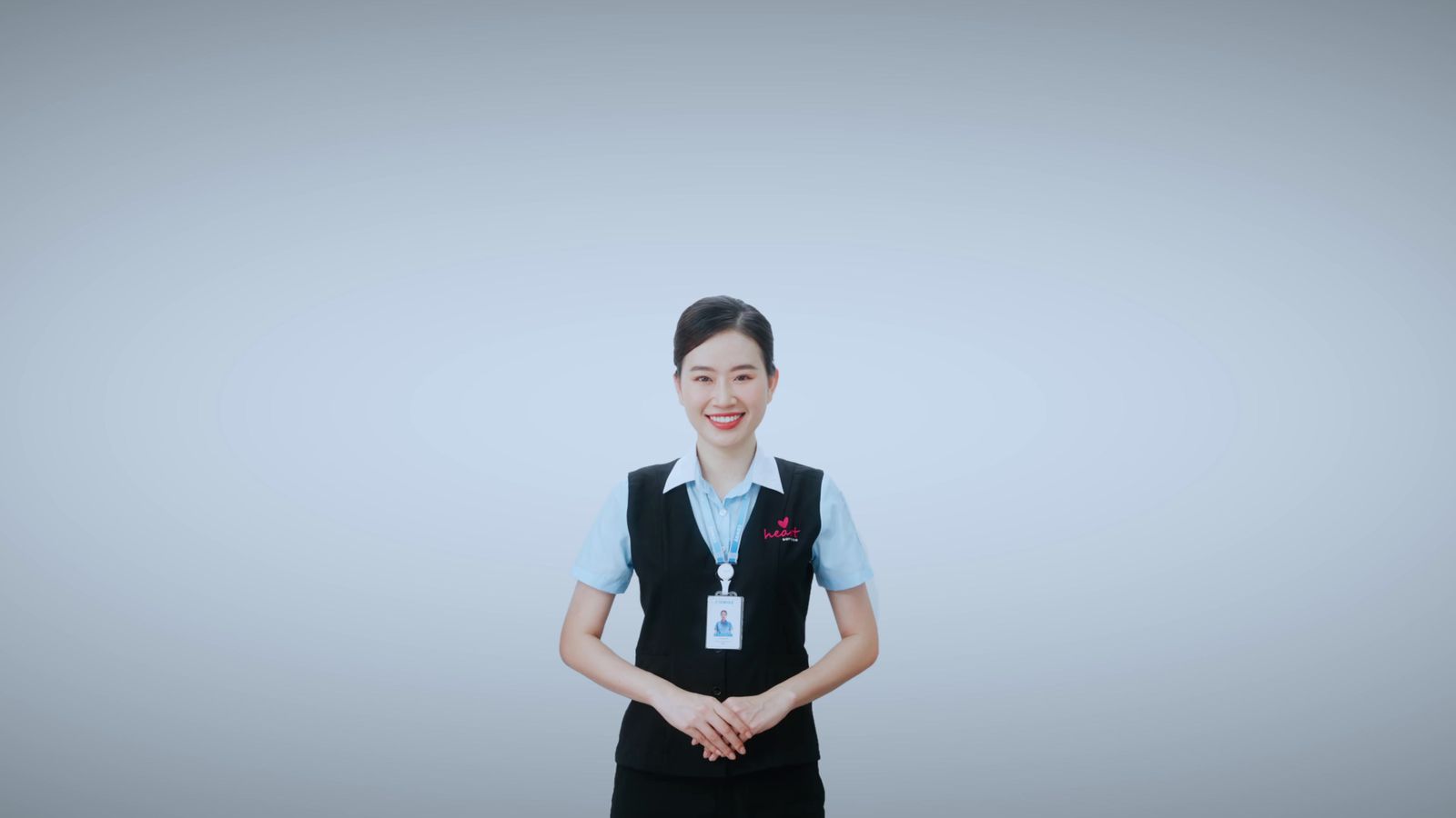 a woman in a blue shirt and black apron