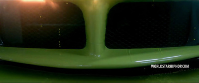 a close up of the front of a green car