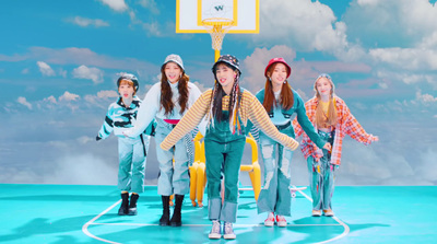 a group of young women standing on top of a basketball court