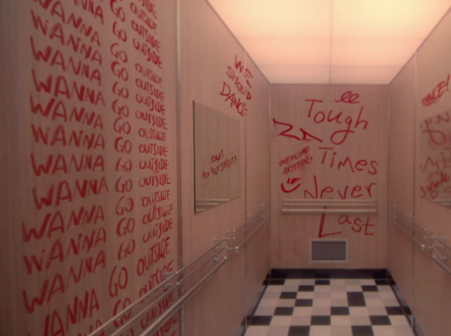 a hallway with red writing on the walls and a black and white checkered floor