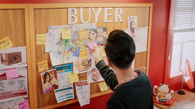 a young boy writing on a bulletin board