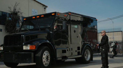 a man standing in front of a large truck