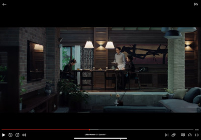 a man standing in a living room next to a table