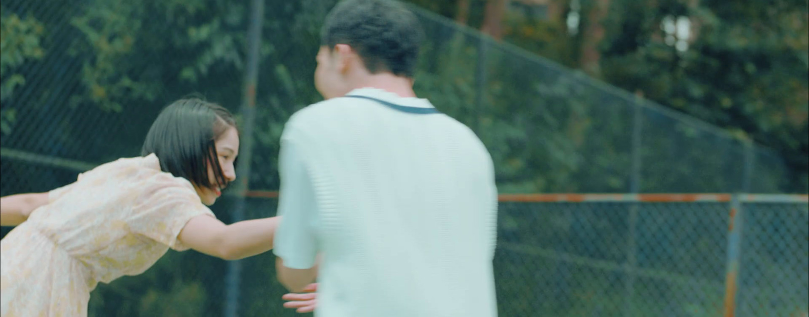 a man and a woman playing tennis on a tennis court