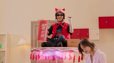 a woman sitting on top of a table next to a statue of a cat