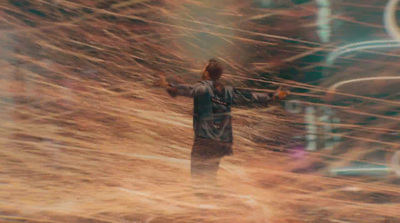 a blurry image of a man standing in a field