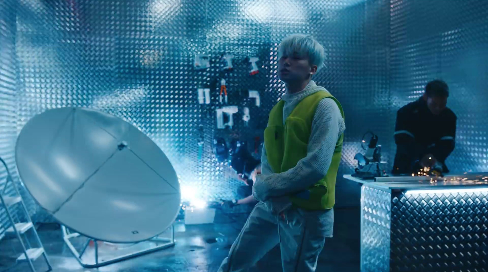 a man standing in front of a satellite dish