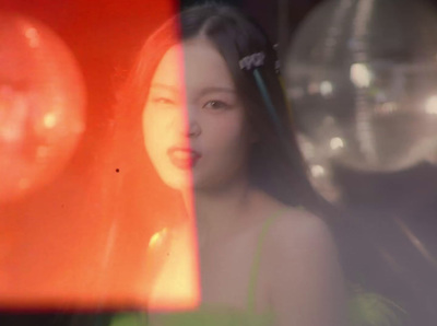 a woman in a green dress looking out a window