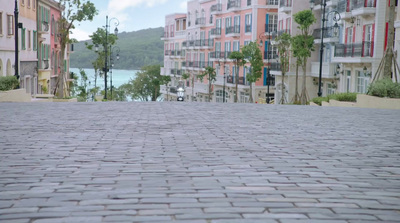 a person riding a skateboard down a brick road