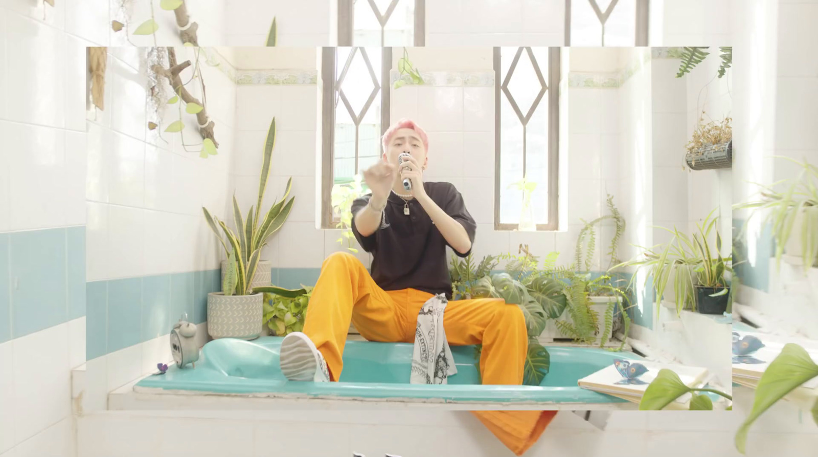 a man sitting on a bath tub in a bathroom