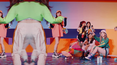 a group of young women sitting on top of a stage