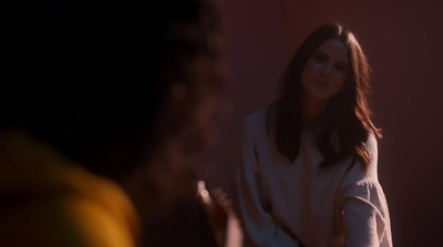 a woman standing in front of a mirror in a room