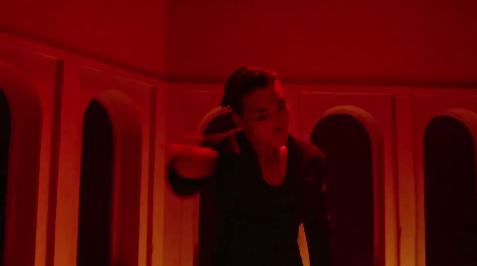 a woman standing in a room with a red light